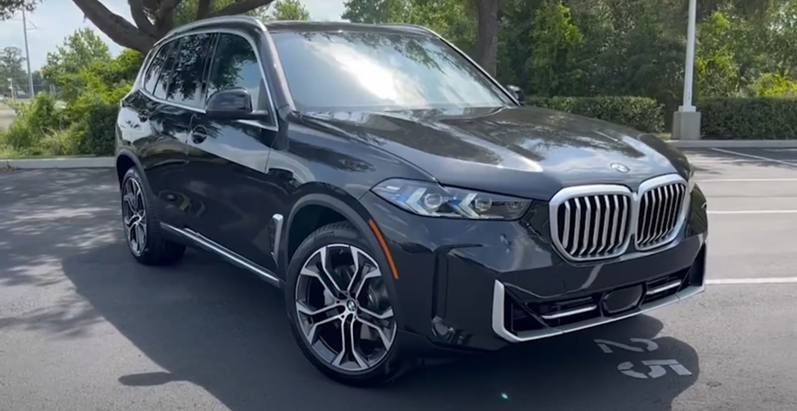 Front three-quarter view of a black 2024 BMW X5