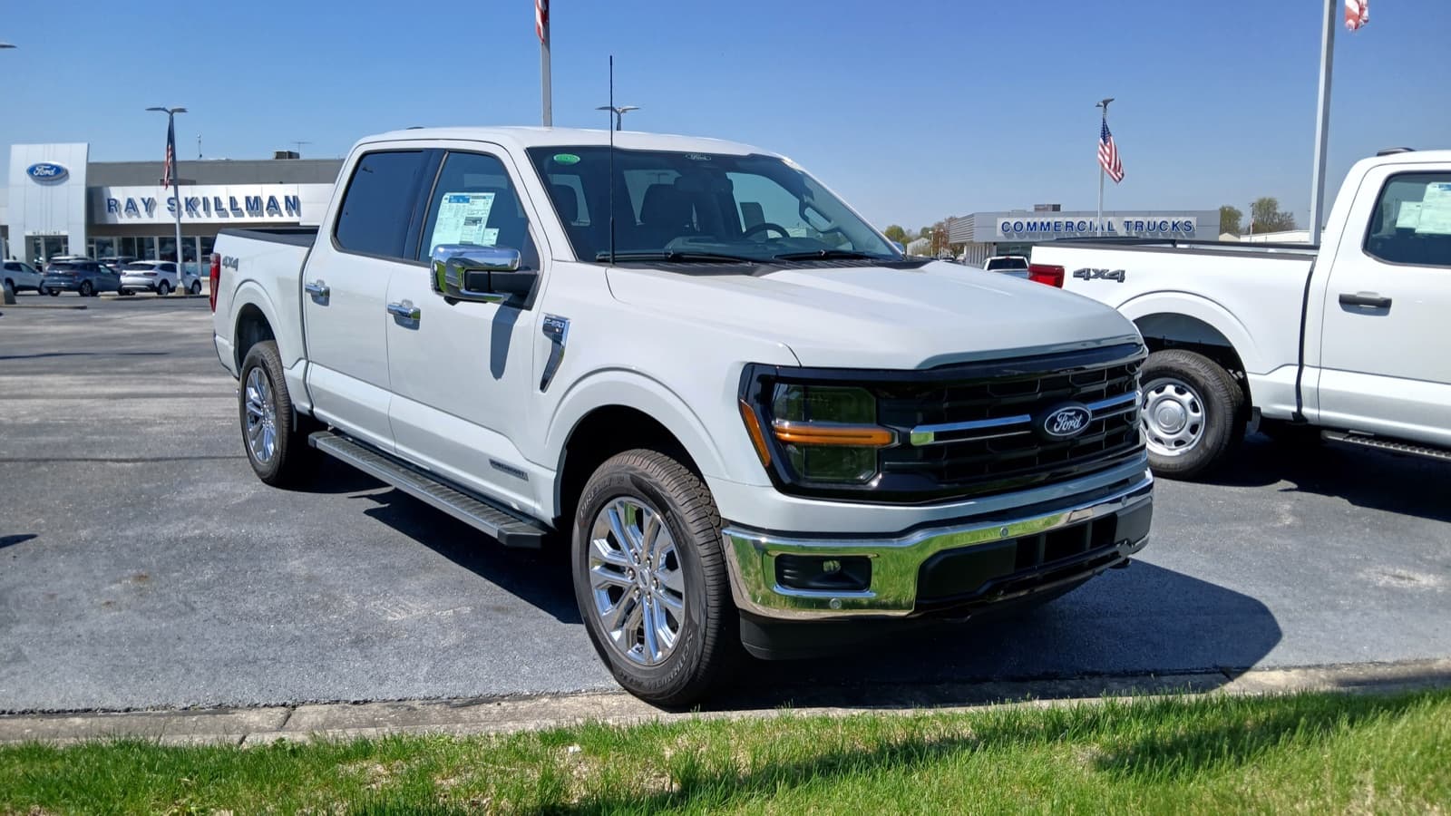 Front three-quarter view of a white 2024 Ford F-150 XLT